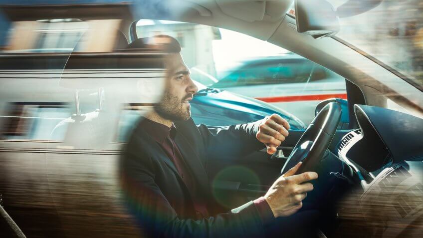 Businessman driving car.