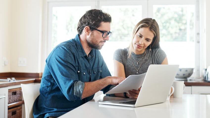Shot of a young couple working on their finances together at home.