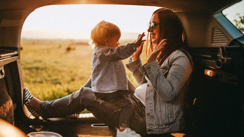 mom with daughter in car on roadtrip