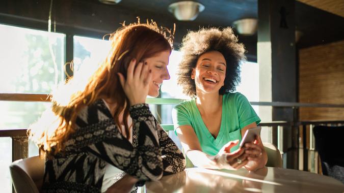 Cute and lovely girlfriends enjoying their time together at the cafe.