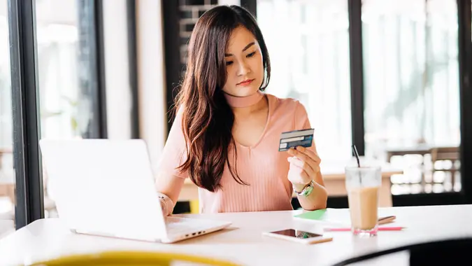 woman looking at her credit card