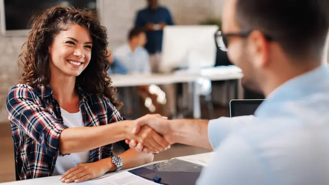 woman signing contracts and handshake with a manager