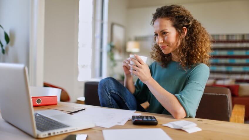 Single, woman at home with technology.