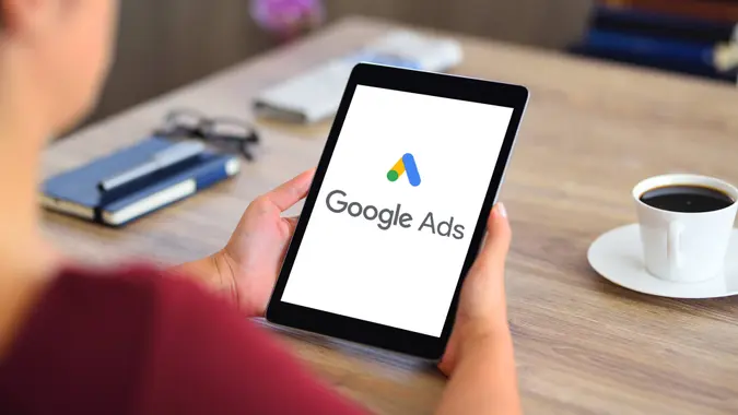 Woman using Google Ads on tablet