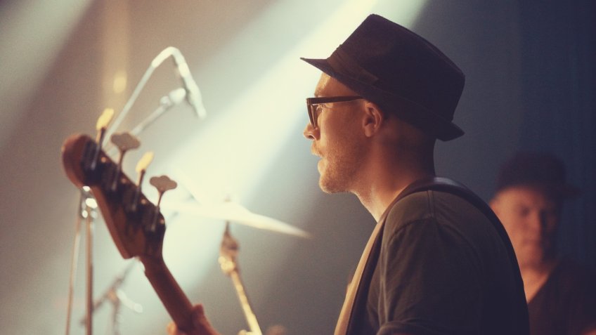 A young guitarist performing on stage.