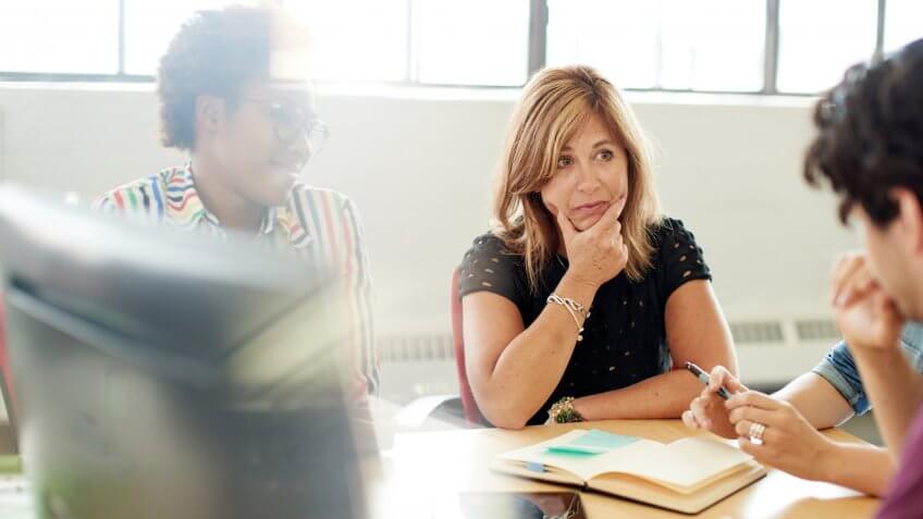 Candid picture of a female boss and business team collaborating.