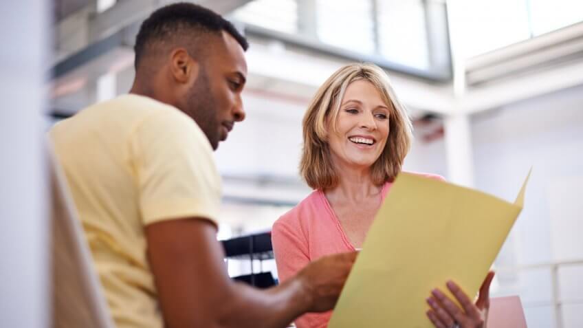 Shot of two business colleagues having a discussion about work.