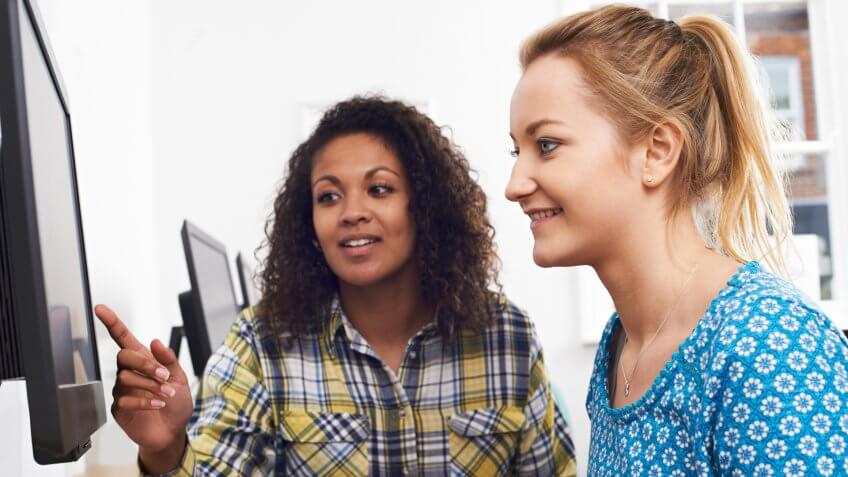 Businesswoman Giving Computer Training In Office.