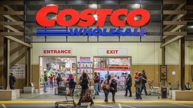 Rancho Cordova, California, USA - December 1, 2016: Late evening shot of people walking in and out of a Costco Wholesale warehouse in Rancho Cordova.