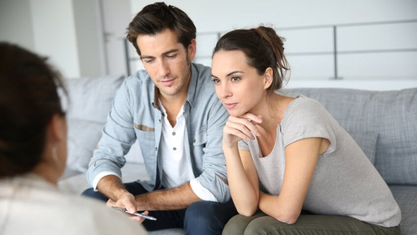 Couple meeting architect for house construction.