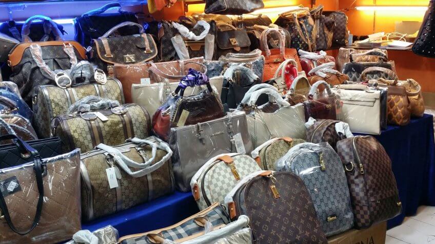 BANDUNG, WEST JAVA ISLAND, INDONESIA -SEPTEMBER 16, 2014: Large collection of famous fake handbags on display at one of the shopping centres in Bandung.