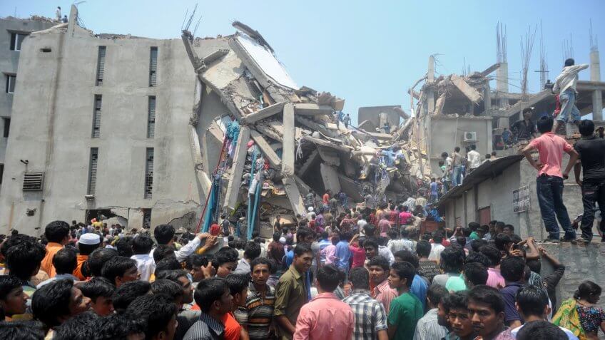 DHAKA, BANGLADESH - APRIL 24, 2013: Rescue workers try rescue trapped garment workers in the Rana plaza building which collapsed in Saver near Dhaka, Bangladesh on April 24, 2013.