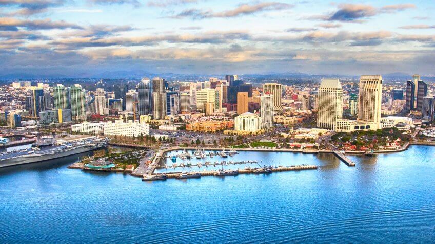 The skyline of downtown San Diego, California shot from an orbiting helicopter of San Diego Bay.