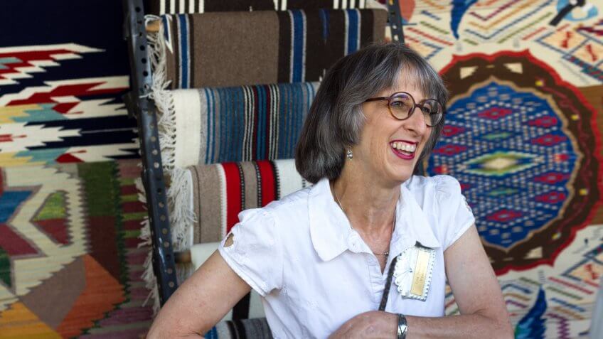 Santa Fe, NM, USA - July 29, 2017: Lisa Trujillo, a New Mexico weaver, sells her textiles at the 2017 Spanish Market in Santa Fe, NM.