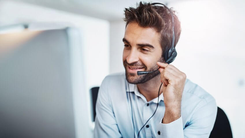 Shot of a young call centre agent working in an office.