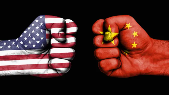 Conflict between USA and China, male fists - governments conflict concept.