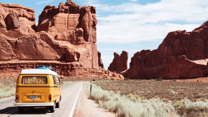 Vintage van driving through southwest landscape