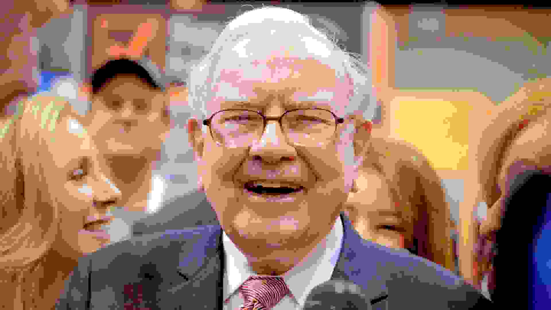 Berkshire Hathaway Chairman and CEO Warren Buffett laughs while touring the exhibit floor at the CenturyLink Center in Omaha, Neb