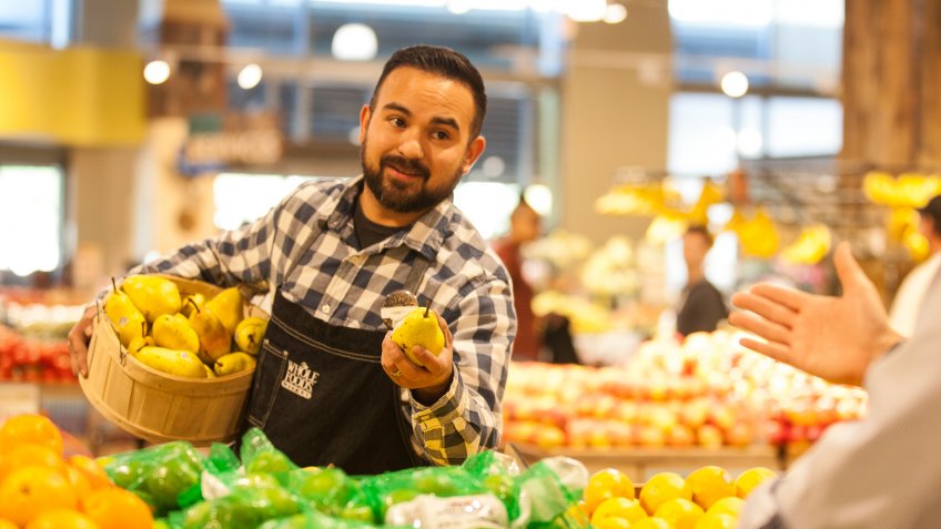 Whole Foods team member assisting customer