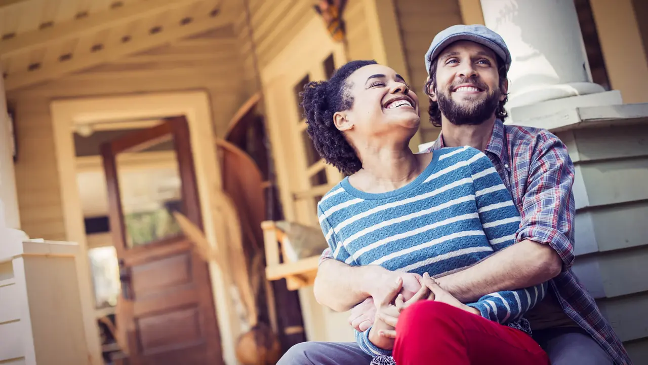 a man and woman seated on the porch steps