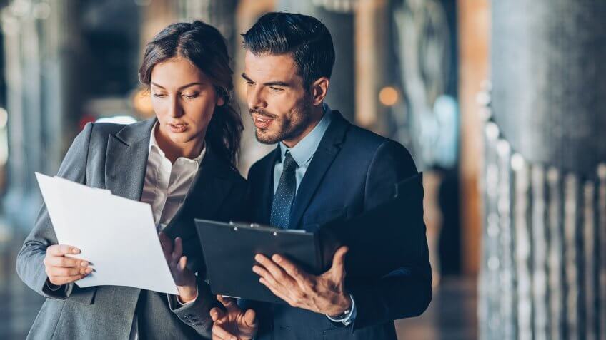 Business persons looking at documents.