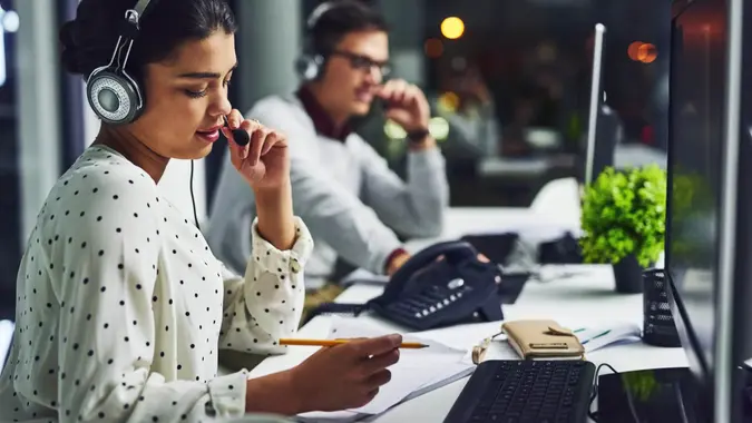 Shot of young call centre agents working late in an office.