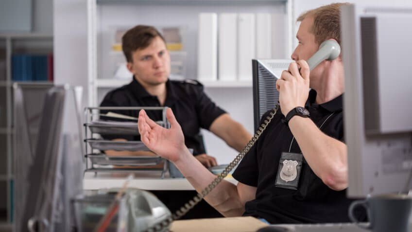 Image of policeman talking on the phone.