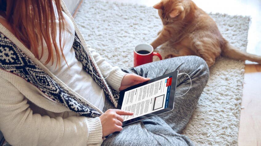 girl reading news on tablet