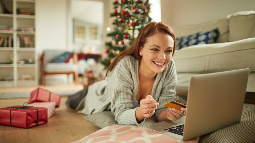 Close up of a young woman buying presents online.