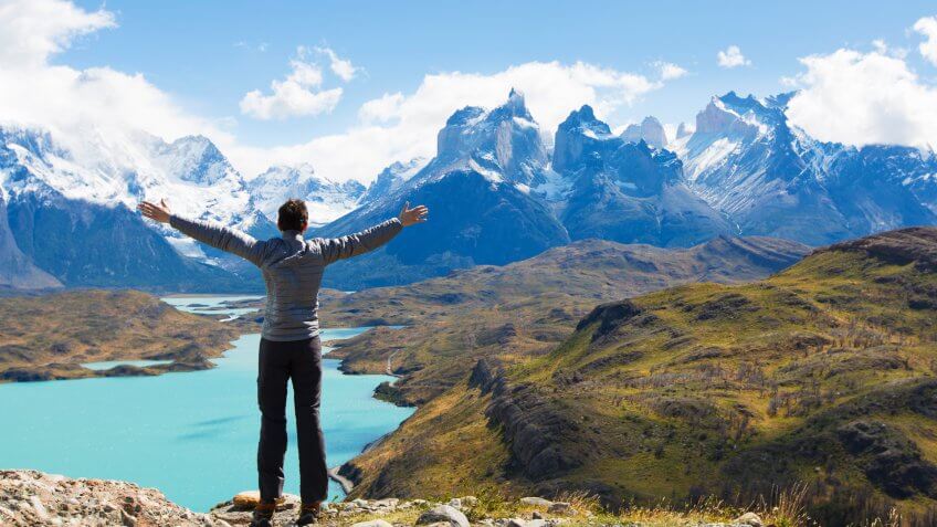 man at mirador condor enjoying hiking and view of cuernos del paine in torres del paine national park, patagonia, chile.