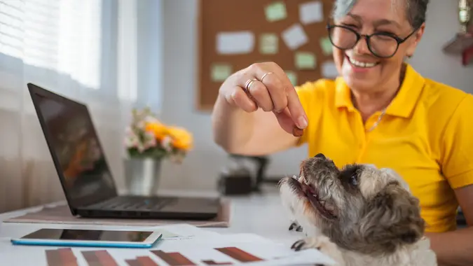 Close up of Caucasian woman and her dog working at home.