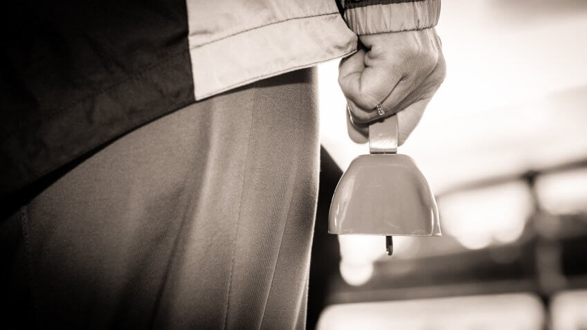 Woman holds a cowbell during race in Upstate New York.