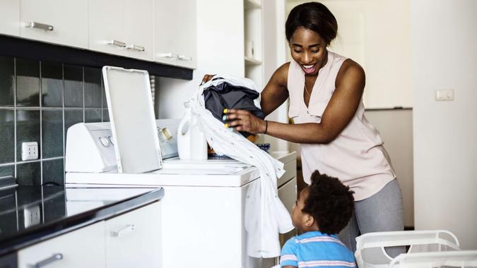 kid helping mom doing the laundry.