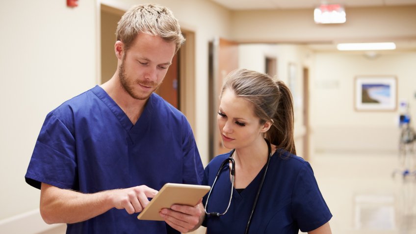 male nurse talking with female nurse