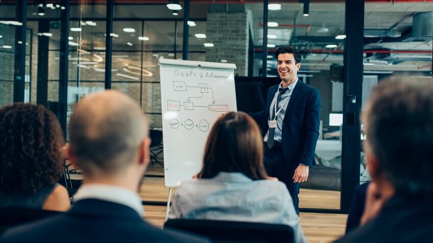 Businessman giving flipchart business presentation.