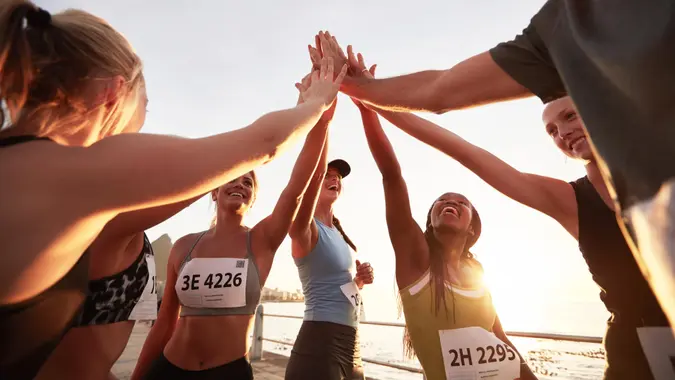 Runners high fiving each other after a good training session.