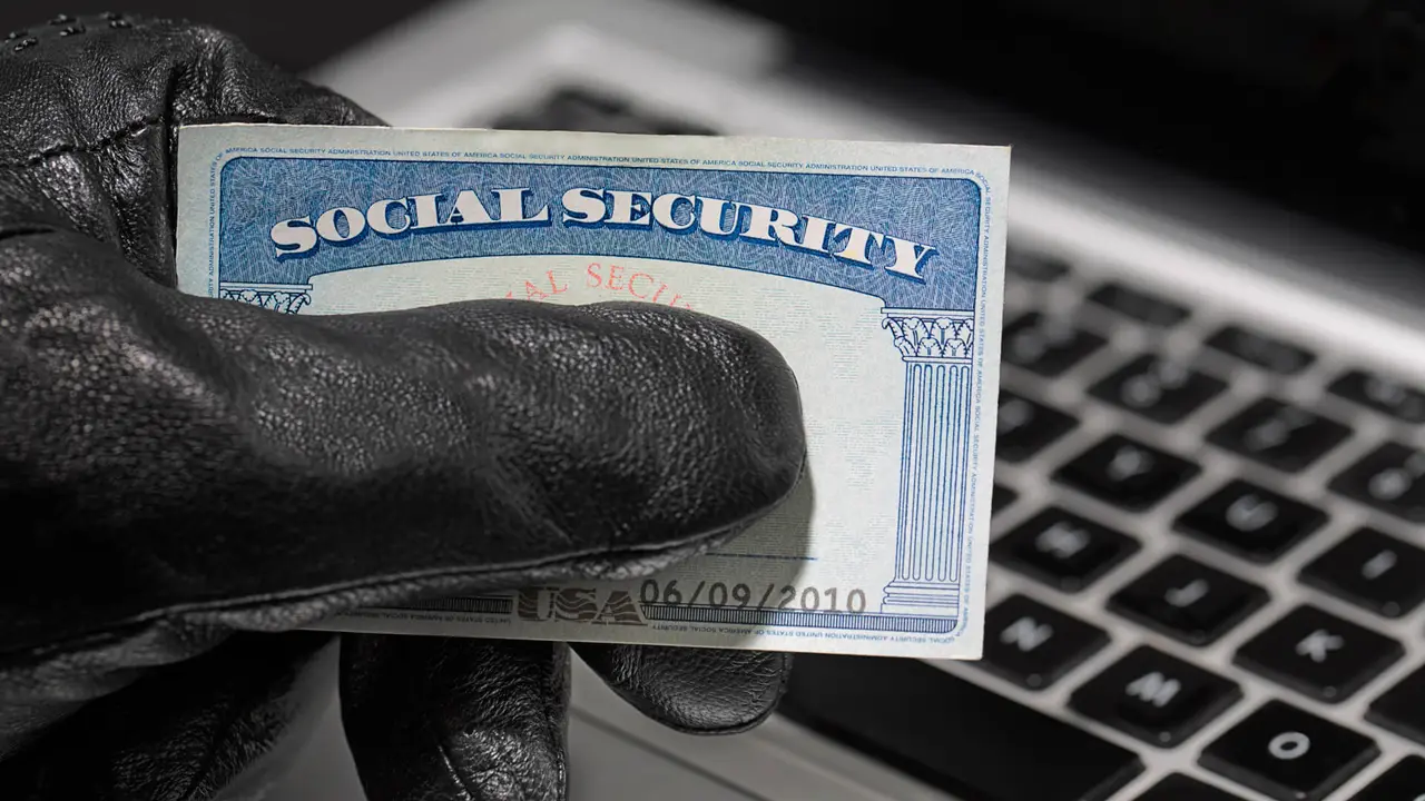 Thief holding a social security card.