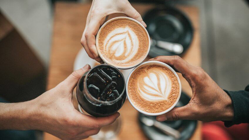 three friends drinking coffee together