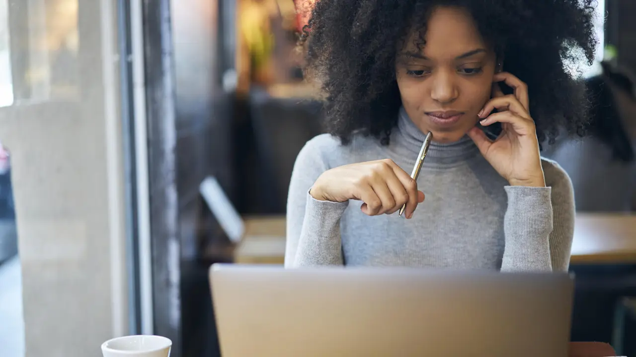 Confident successful female administrative manager of trading corporation making online parley with business partners discussing details of collaboration using laptop computer and free wifi connection.