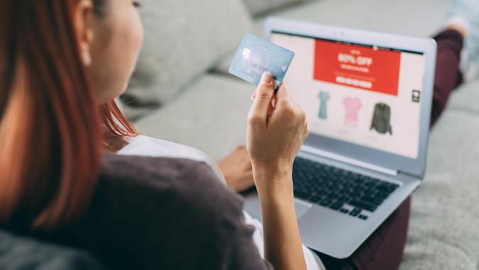 Online shopping Woman making online payment via laptop at home.