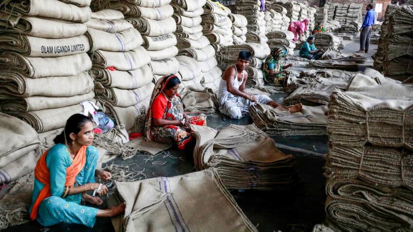 DHAKA, BANGLADESH - MARCH 05, 2018: workers sewing jute bags at a factory on the outskirts of Dhaka, Bangladesh on March 05, 2018.