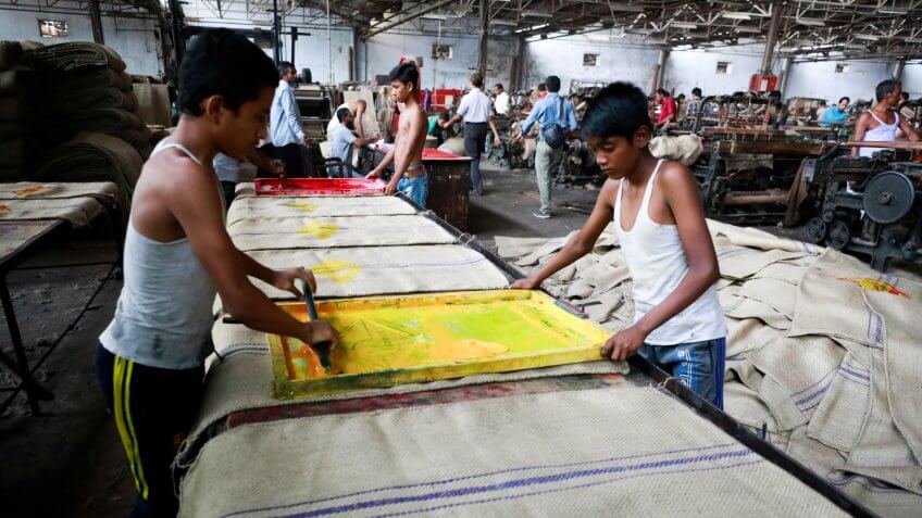 DHAKA, BANGLADESH - MARCH 05, 2018: workers sewing jute bags at a factory on the outskirts of Dhaka, Bangladesh on March 05, 2018.