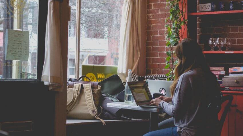 woman using laptop in a cafe or home