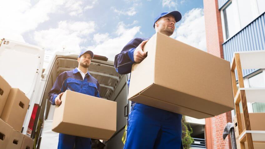 a pair of movers carrying boxes