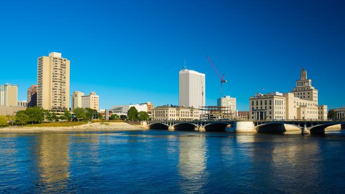 Downtown Cedar Rapids skyline with First Avenue Bridge and Cedar River in the foreground.