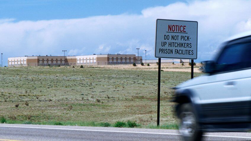 Do not pick-up hitchikers sign on a road passing by prision facilities in New Mexico, USA.