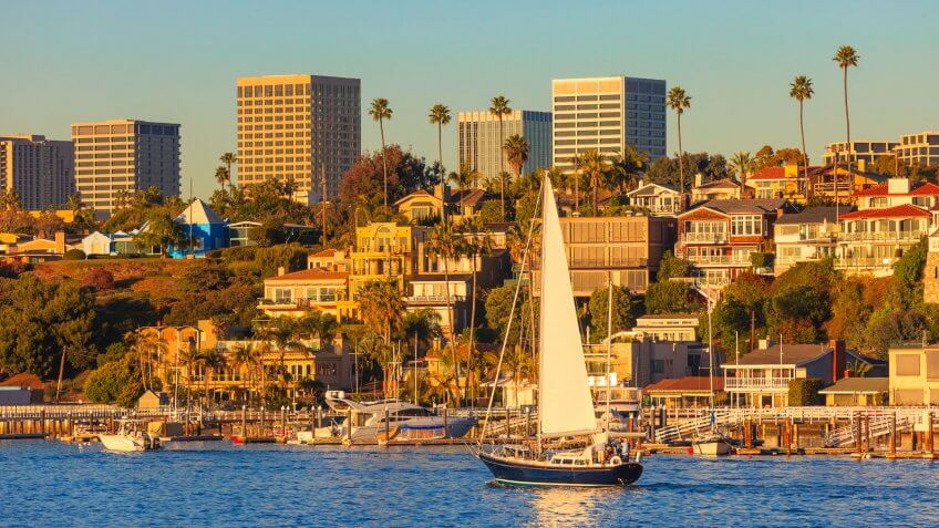 Newport Beach houses with the Fashion Island skyline in the background.