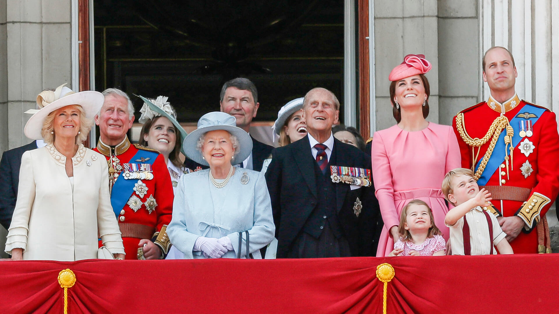 the-prince-and-princess-are-smiling-together-in-front-of-an-image-that