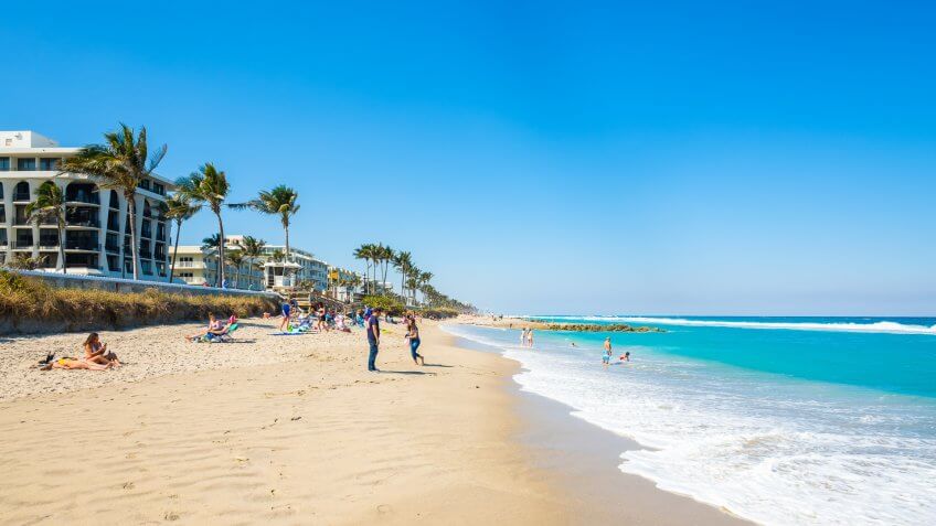 West Palm Beach, Florida - March 14, 2018: Visitors enjoying the beauty and warm winter weather at the beach along Ocean Boulevard and Worth Avenue.