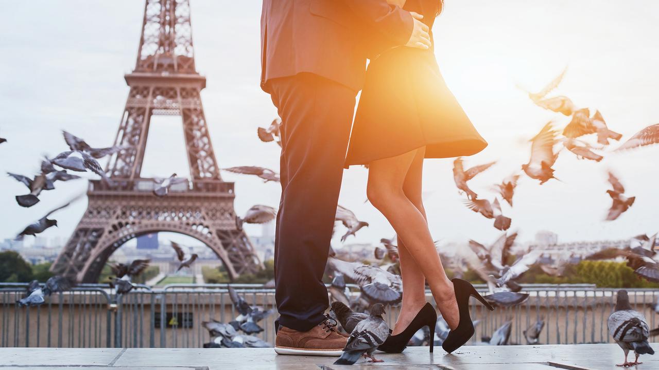 couple near Eiffel tower in Paris, romantic kiss.